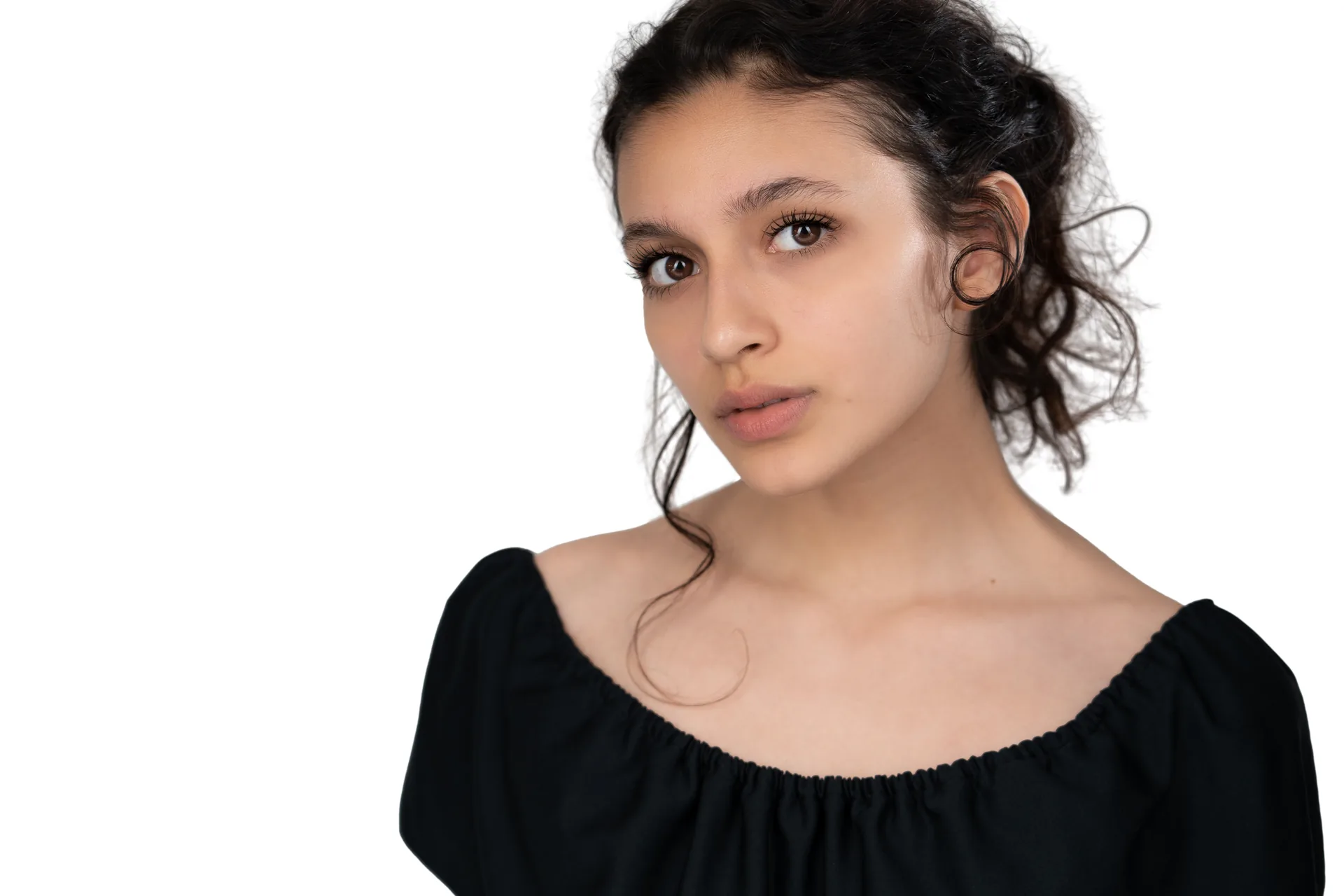 Actor headshot of a woman with curly hair on a white background