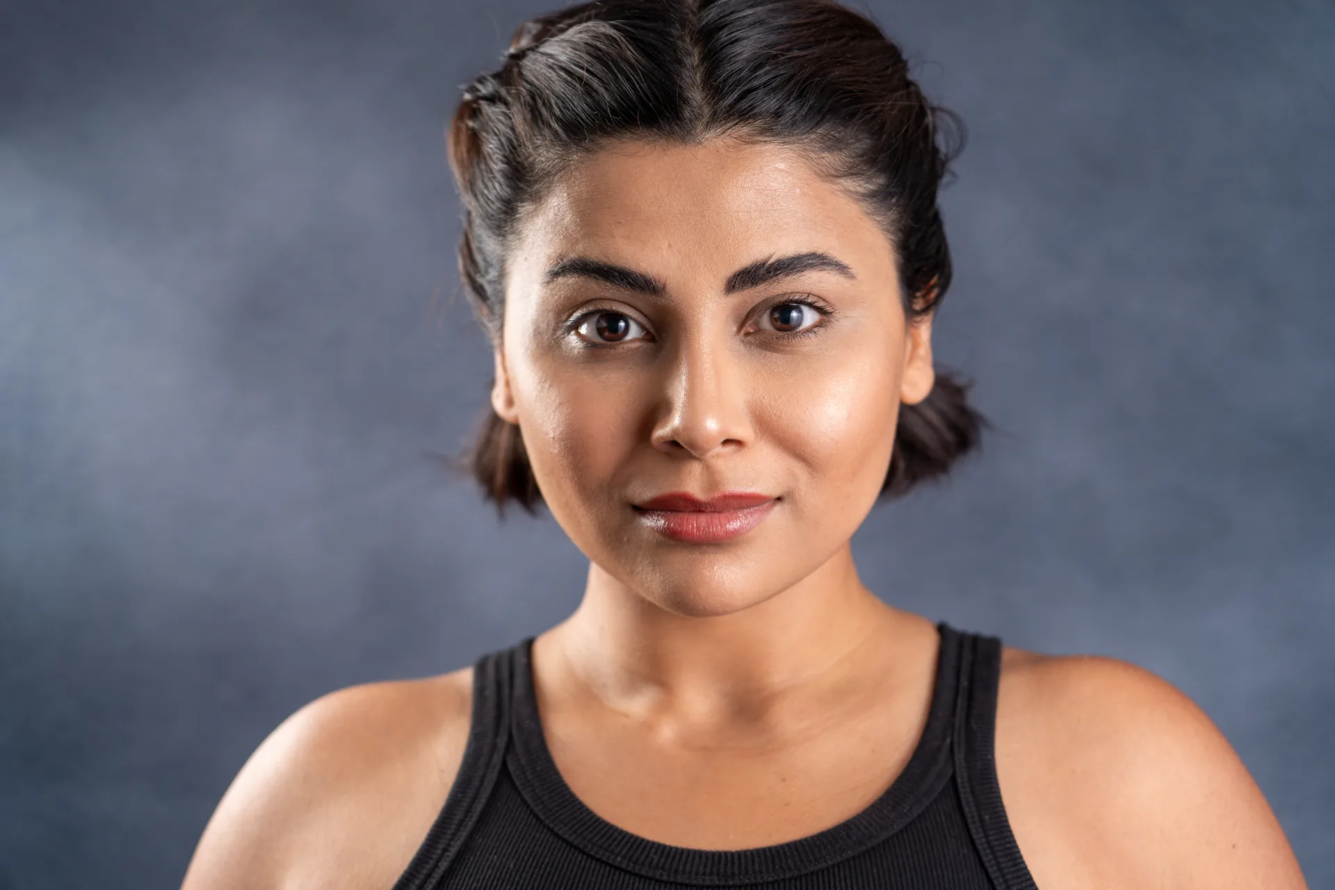 Dramatic actor headshot of a woman on a dark background